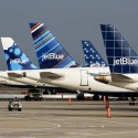 a group of airplanes parked on a runway