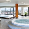 a room with a hot tub and a large window