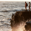 a group of people standing on a rock