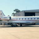 a white airplane parked in a hangar