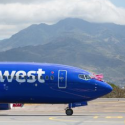 a blue airplane on a runway