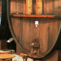 a large wooden barrel with a wooden handle