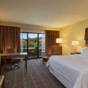 a hotel room with a desk and chair