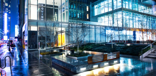 a building with a lot of trees and a bench