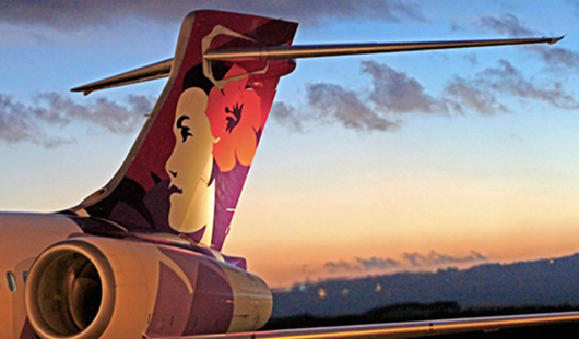 the tail of an airplane with a woman's face on it