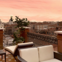 a balcony with chairs and a fence