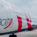 a large white airplane with red and white text on it