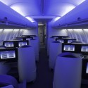 an airplane with rows of seats and monitors