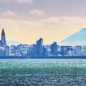 a city skyline with a mountain in the background