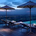 a pool with umbrellas and lounge chairs