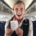 a woman holding a piece of paper in a plane