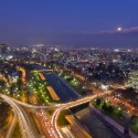 a city at night with a river and a bridge