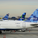 a group of airplanes parked on a runway