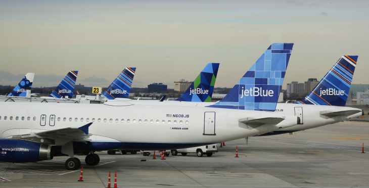 a group of airplanes parked on a runway