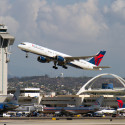 a plane flying over a runway