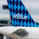 the tail of an airplane with blue and white checkered pattern