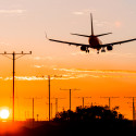 an airplane flying over a runway