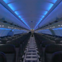 an inside of an airplane with rows of seats