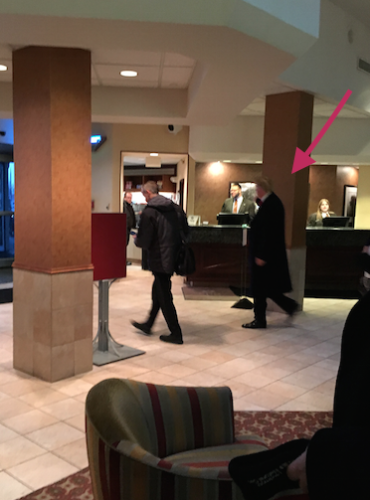 a group of people in a hotel lobby