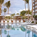 a pool with lounge chairs and umbrellas