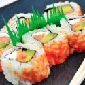 a plate of sushi with chopsticks