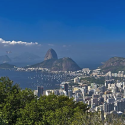 a cityscape with mountains and water