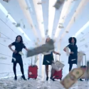 a group of women with luggage in a hallway