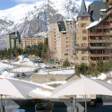 a snowy mountain landscape with buildings and trees