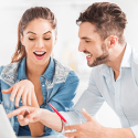 a man and woman looking at a laptop