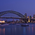 a bridge over water with boats in the foreground