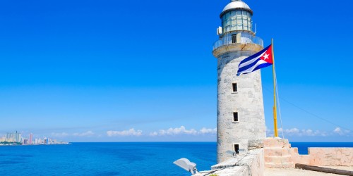 a lighthouse with a flag on top of it