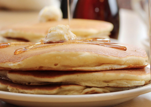 a stack of pancakes with syrup on top