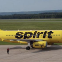 a yellow airplane on a runway