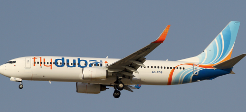 a white airplane with blue and orange text
