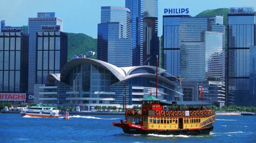 a boat in the water with a city in the background