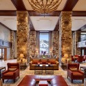 a large room with stone pillars and a chandelier