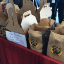 a group of brown paper bags with white labels