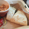 a burrito and rice in a container