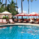 a pool with chairs and umbrellas