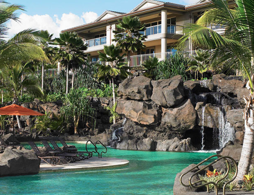 a pool with a waterfall and palm trees