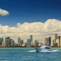 a boat in the water with a city in the background