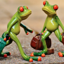 a pair of frogs carrying bags