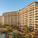 a large building with many balconies and a pool