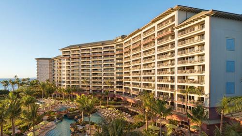 a large building with many balconies and a pool