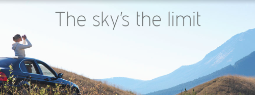 a person on a hill with mountains in the background