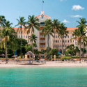 a building with palm trees and a beach