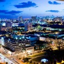 a city at night with buildings and trees