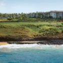 a beach with a body of water and a building