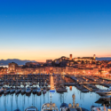 a marina with many boats and buildings in the background