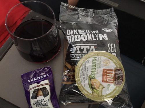 a glass of wine and snacks